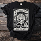 Skull with floral crown, scythes, and poison bottle. Text reads "All Plants Are Edible, Some Only Once."