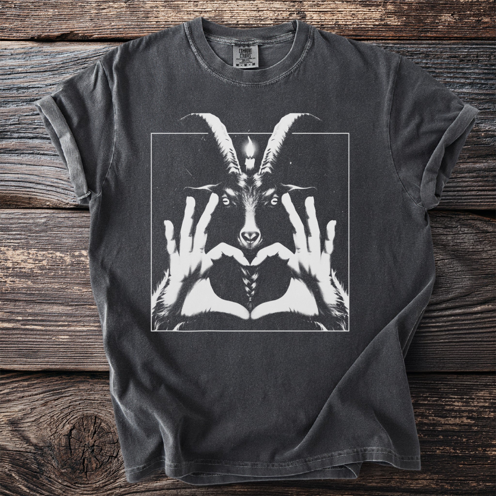 Dark t-shirt with white graphic of a goat head and hands forming a heart.