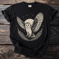 Black t-shirt with barn owl graphic, moon, stars, and fern details.