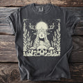 Dark gray t-shirt with an antlered figure with closed eyes and a sun-disc halo above a skull ringed with toadstools.