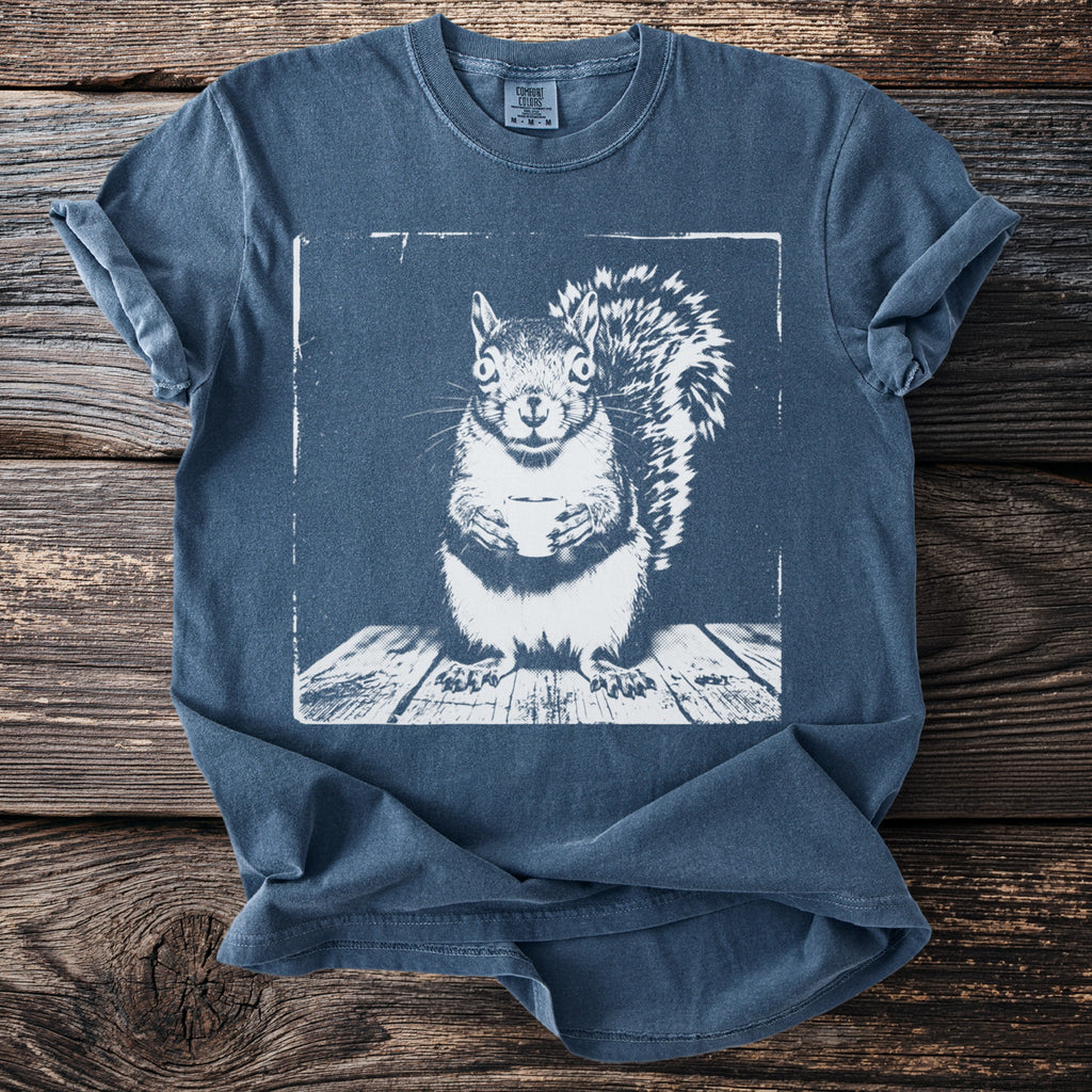 Slate blue t-shirt with a white graphic of a squirrel holding a coffee cup.