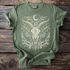 Green t-shirt with occult graphic featuring goat skull, crows, bones and moon.