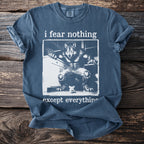 Blue t-shirt with "i fear nothing except everything" text and werewolf and mouse graphic.