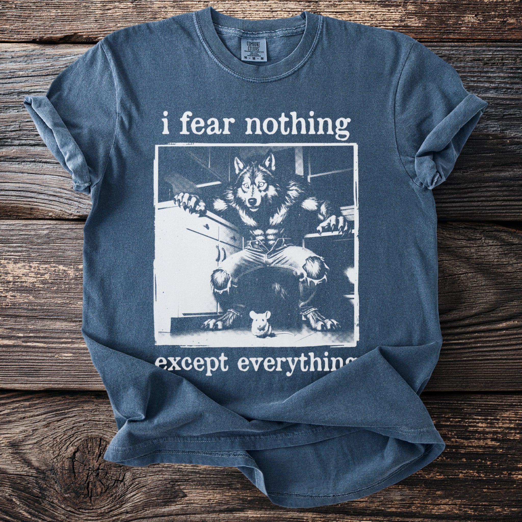 Blue t-shirt with "i fear nothing except everything" text and werewolf and mouse graphic.