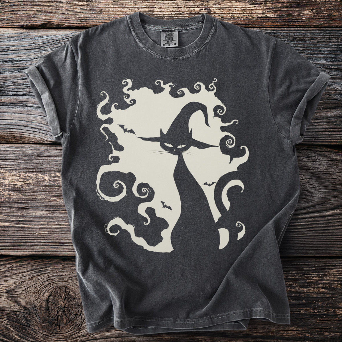 Dark grey t-shirt with a cream graphic of a black cat in a witch hat and swirling smoke.