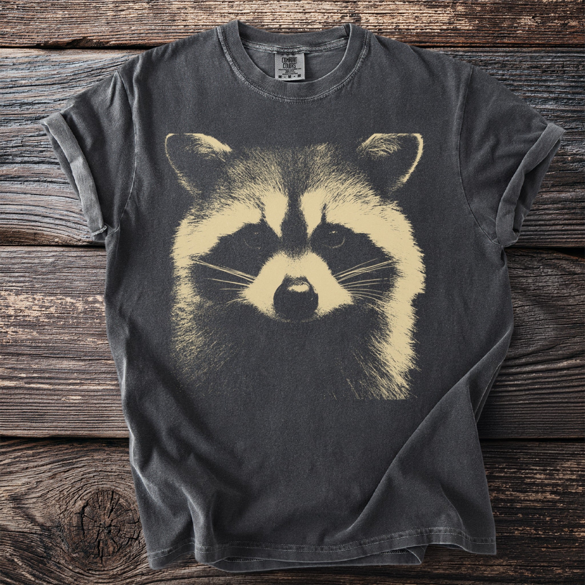 Dark gray t-shirt featuring a close-up graphic of a raccoon's face.