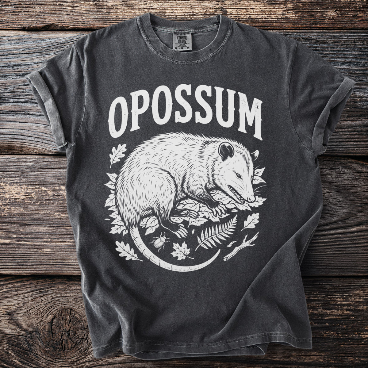 Dark gray t-shirt with "OPOSSUM" text and opossum illustration with leaves and insects.