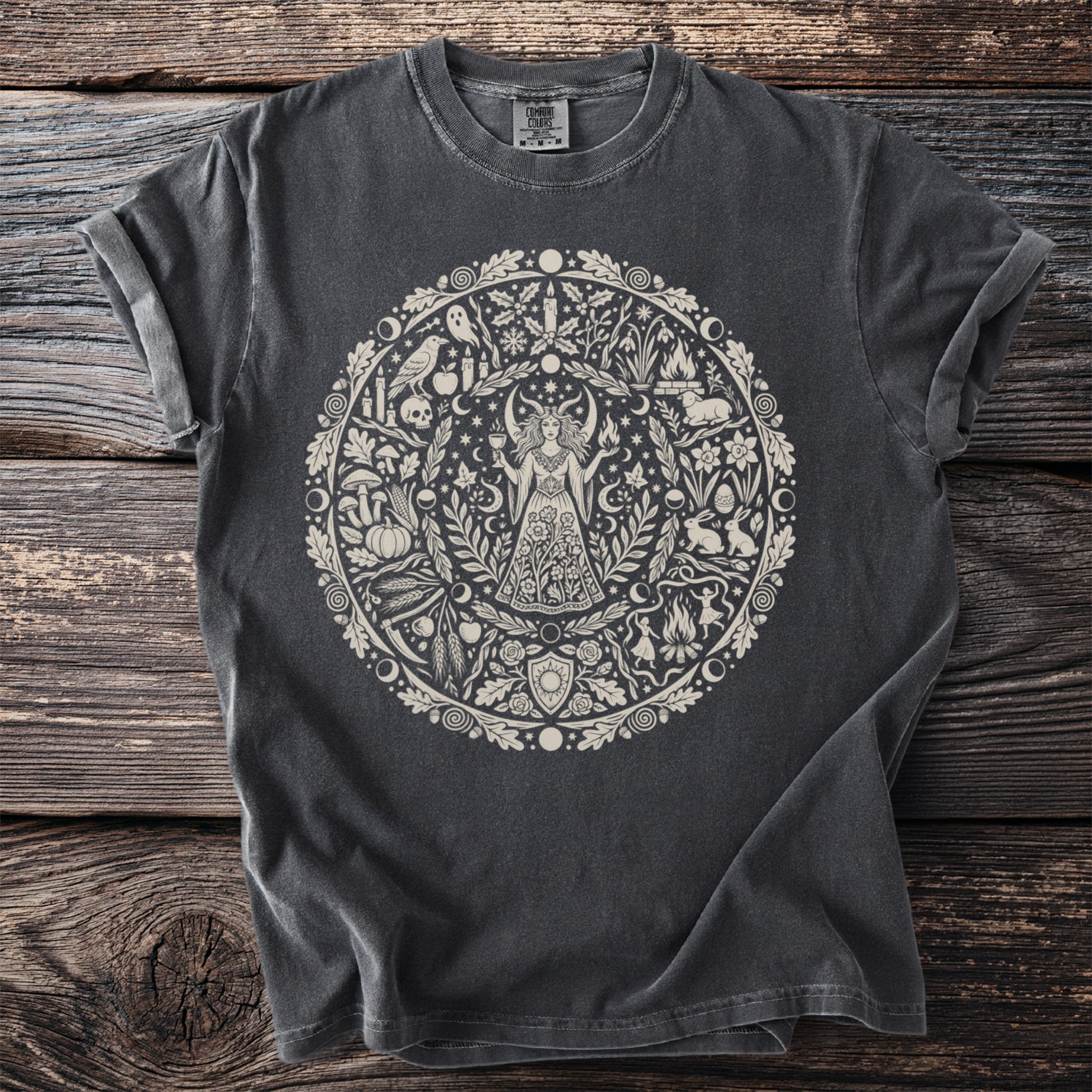 Dark grey t-shirt with a circular cream-colored pagan-themed graphic.