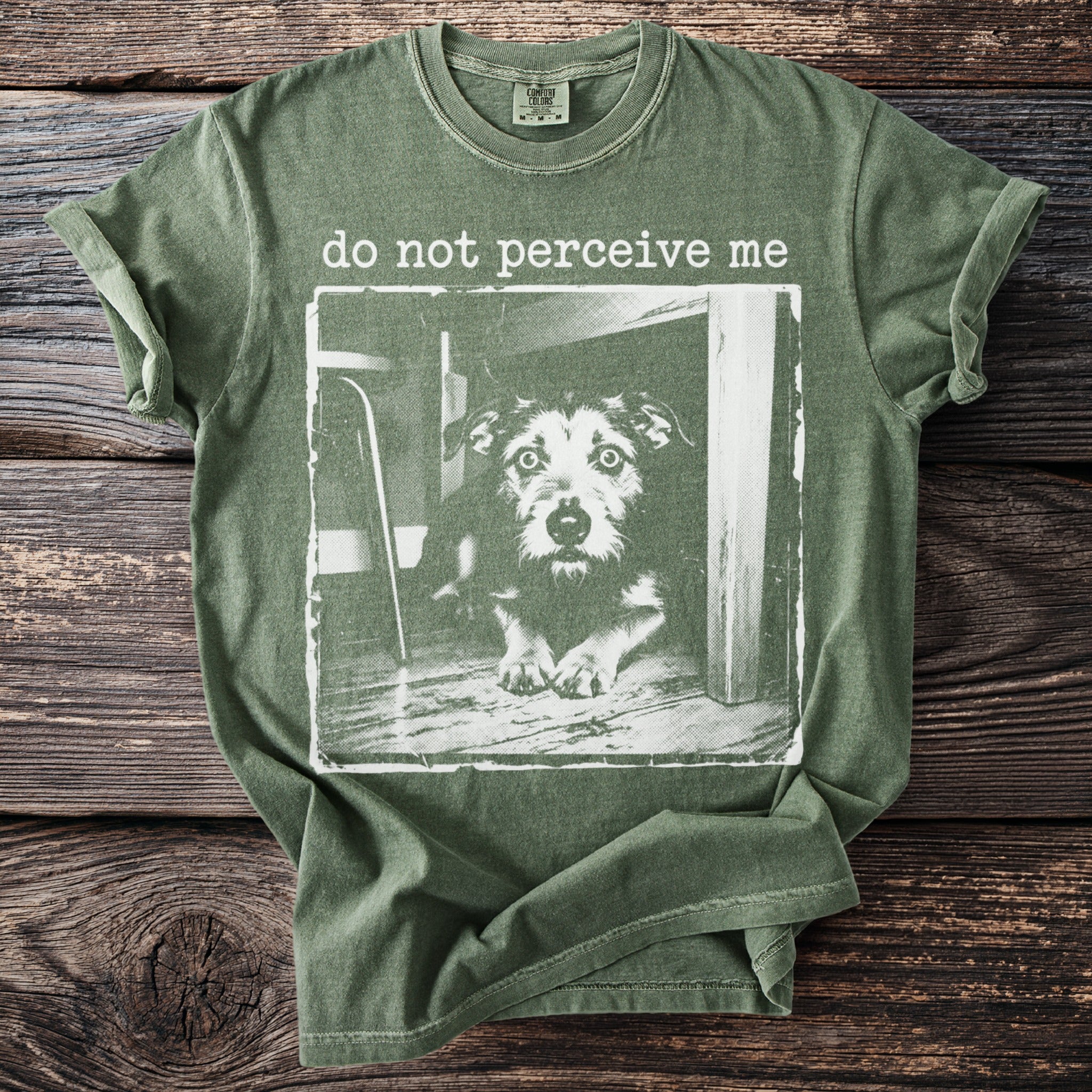 Green t-shirt with a distressed print of a dog and text "do not perceive me".