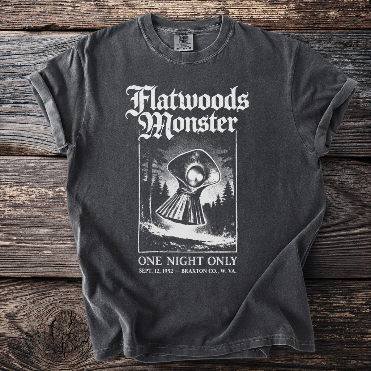 Dark gray t-shirt with "Flatwoods Monster" graphic and "One Night Only" text.