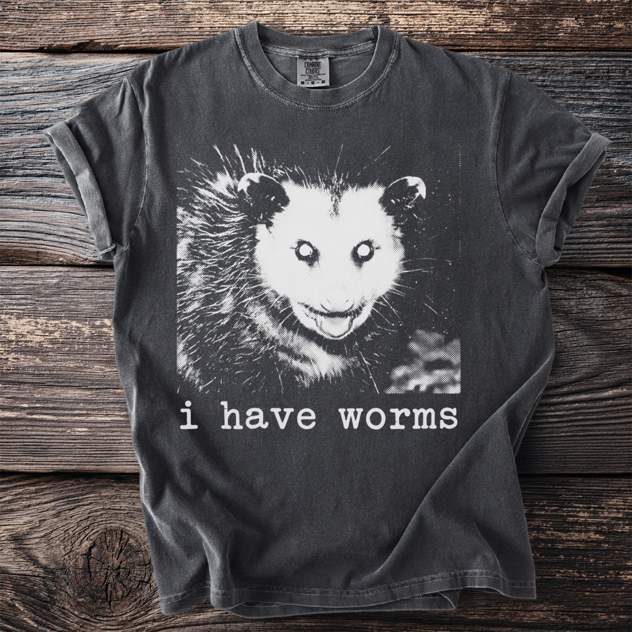 Charcoal gray t-shirt with a distressed possum graphic and text saying "i have worms."