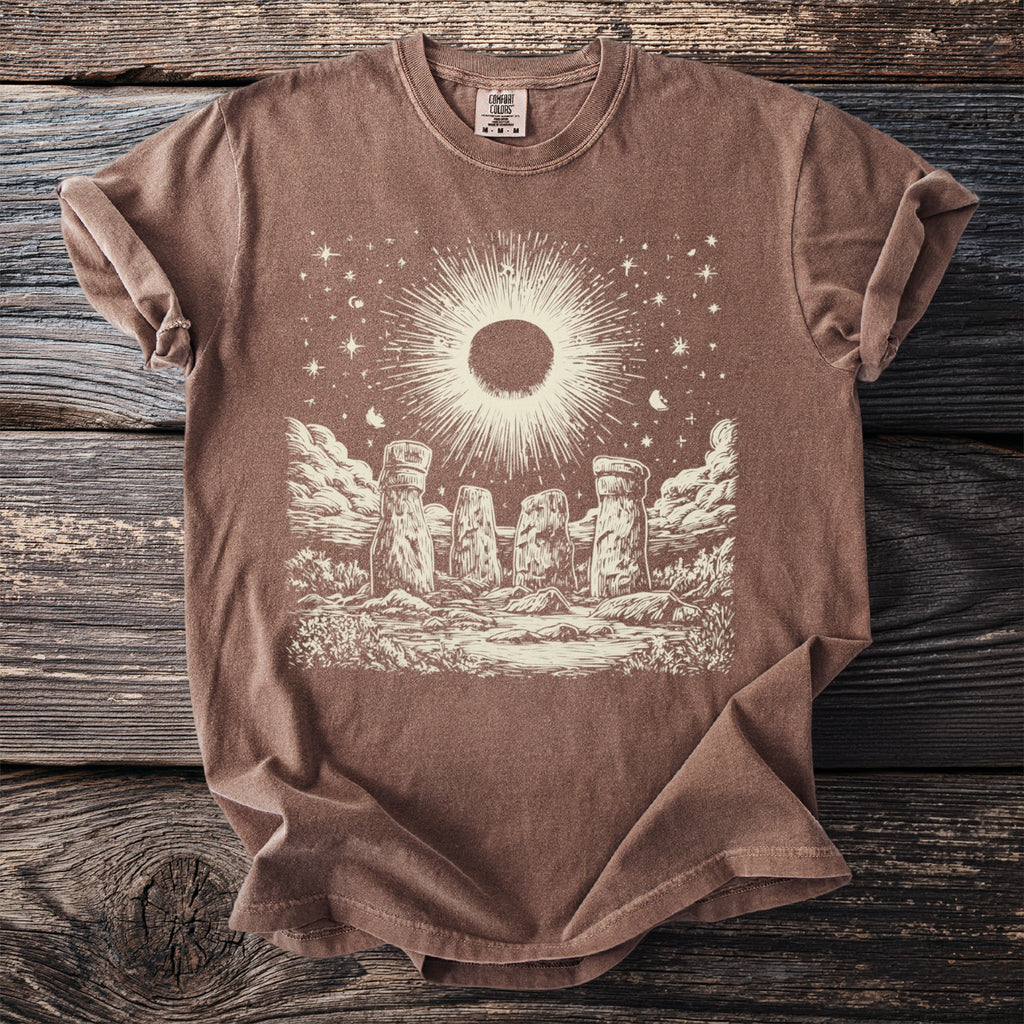 Brown t-shirt with a celestial Stonehenge graphic and "Comfort Colors" tag.