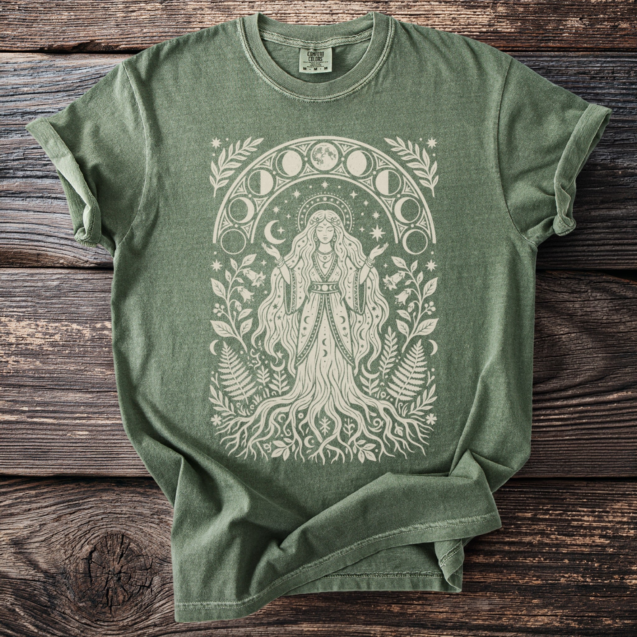 Green t-shirt with a white celestial goddess and moon phase design.