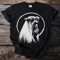 Black t-shirt with white graphic of a person in a veil holding hands to face.