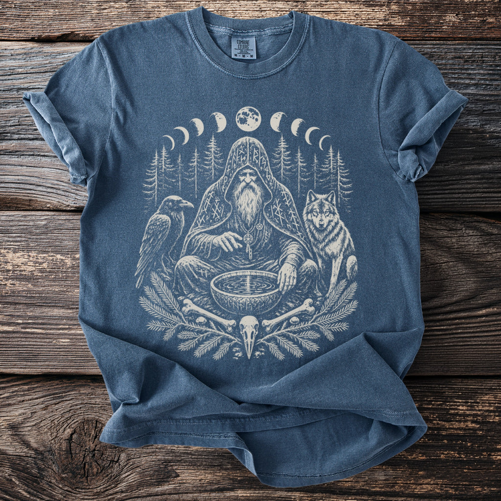 T-shirt with a white graphic of a bearded shaman, wolf, raven, and moon phases.