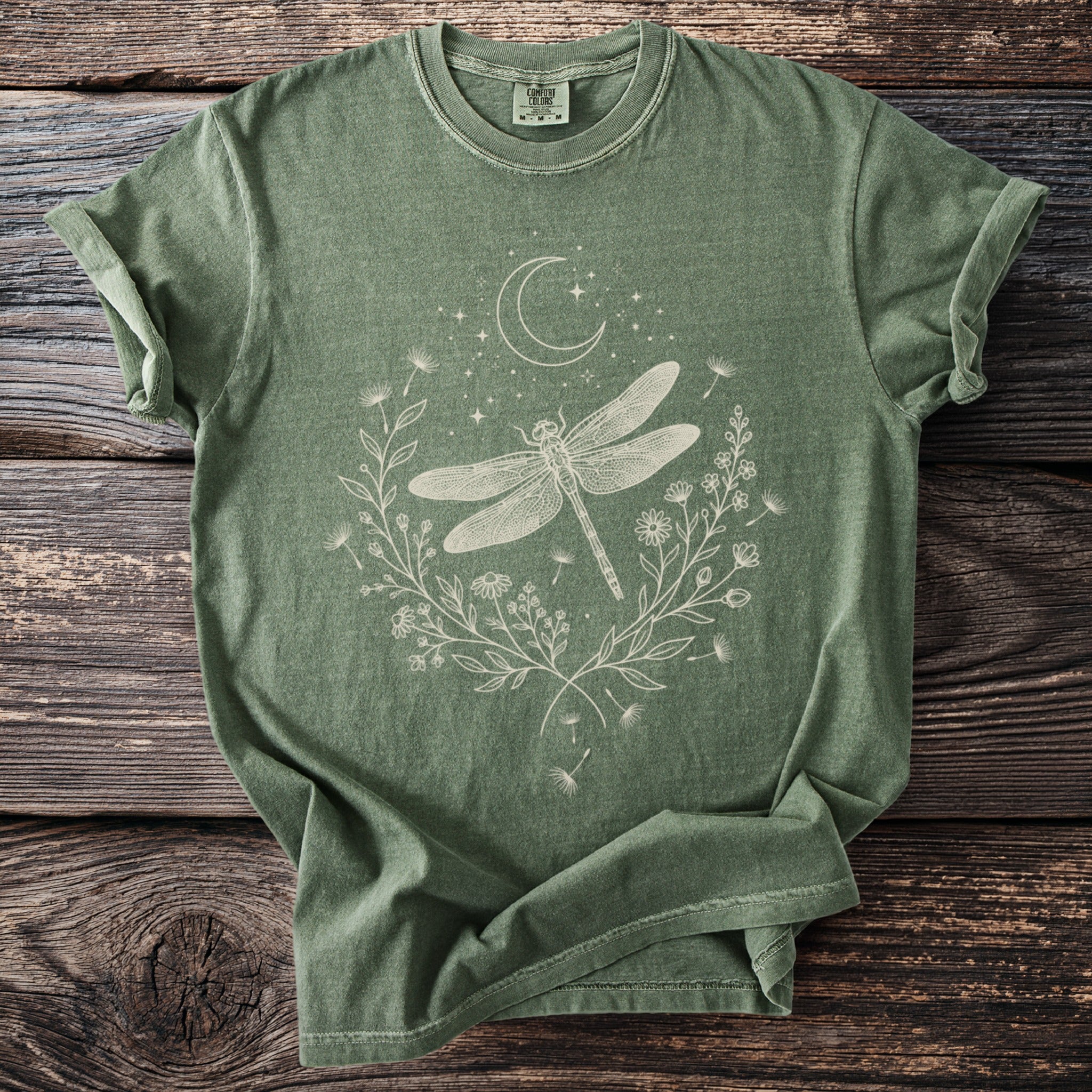 Green t-shirt with white dragonfly, moon, stars, and floral design.