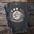 T-shirt with a leaping hare graphic surrounded by moon phases and foliage.