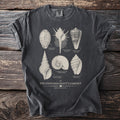 Dark grey t-shirt featuring "The Conchologist's Cabinet" seashell illustration with names.