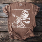 Brown t-shirt with white graphic of a frog under a full moon with trees.