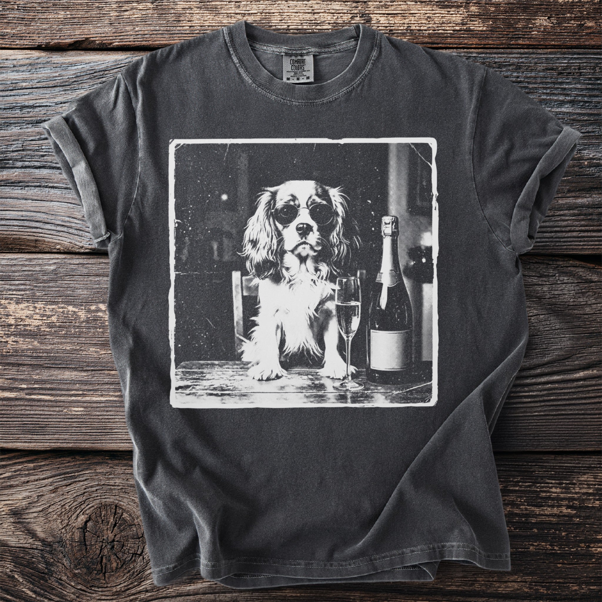Black t-shirt with a vintage print of a dog wearing sunglasses with a champagne bottle and glass.