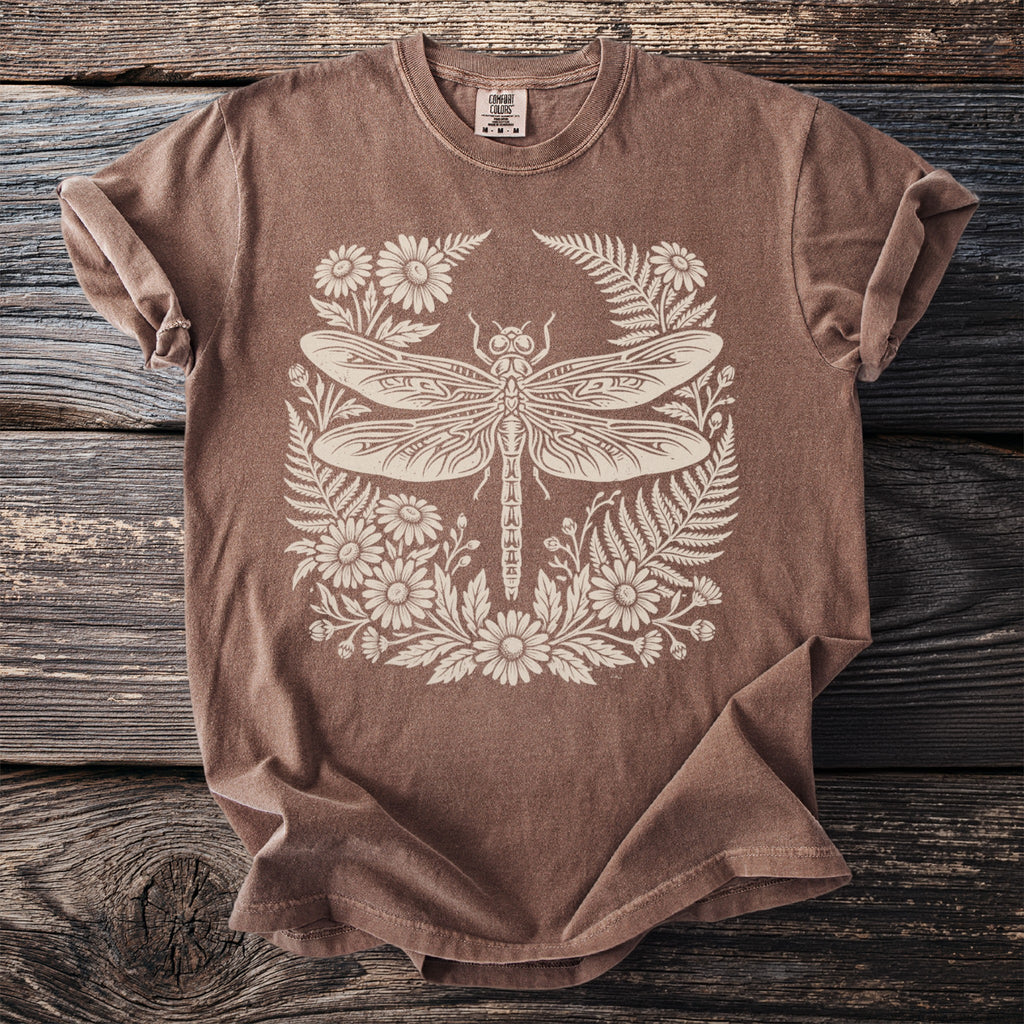 Brown t-shirt with a cream-colored dragonfly and floral graphic.