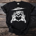 Black t-shirt with witch graphic making a heart shape with her hands.