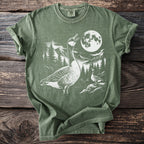 Green t-shirt with white graphic of geese, moon, trees, and mountains.