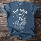 Blue t-shirt with white graphic of "The Star" tarot card and celestial elements.