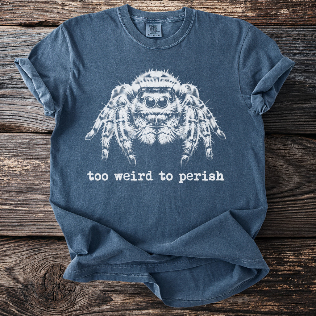 Blue t-shirt with white jumping spider graphic and text reading "too weird to perish".