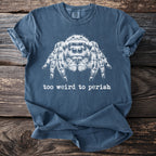 Blue t-shirt with white jumping spider graphic and text reading "too weird to perish".