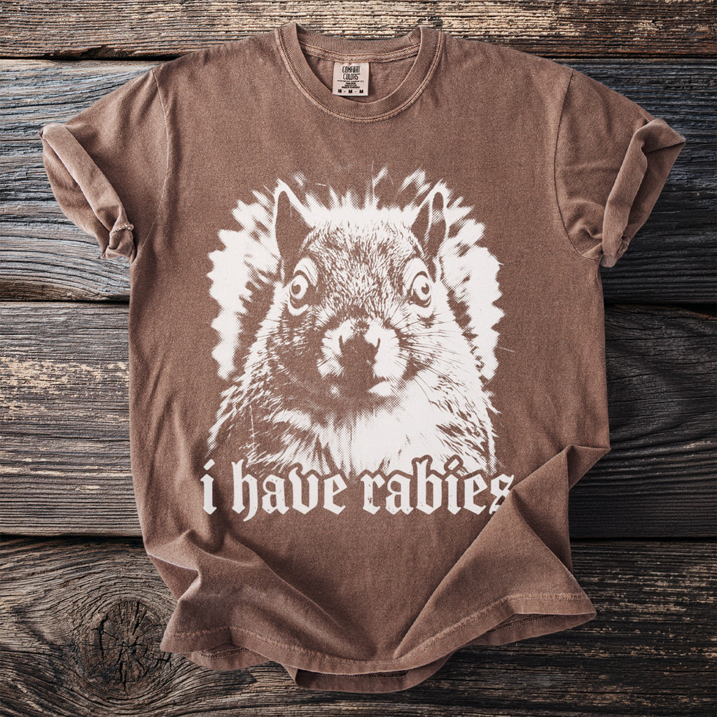 Brown t-shirt with a startled squirrel graphic and "i have rabies" text.