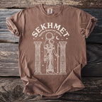 Brown t-shirt with white line art of Sekhmet, Egyptian lioness war goddess.