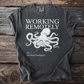 Dark t-shirt with "WORKING REMOTELY" text, an octopus graphic, and "Fig. 1: Distributed Intelligence."