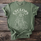 Green t-shirt with Cyclops graphic, "greek mythology one eyed giant" text.