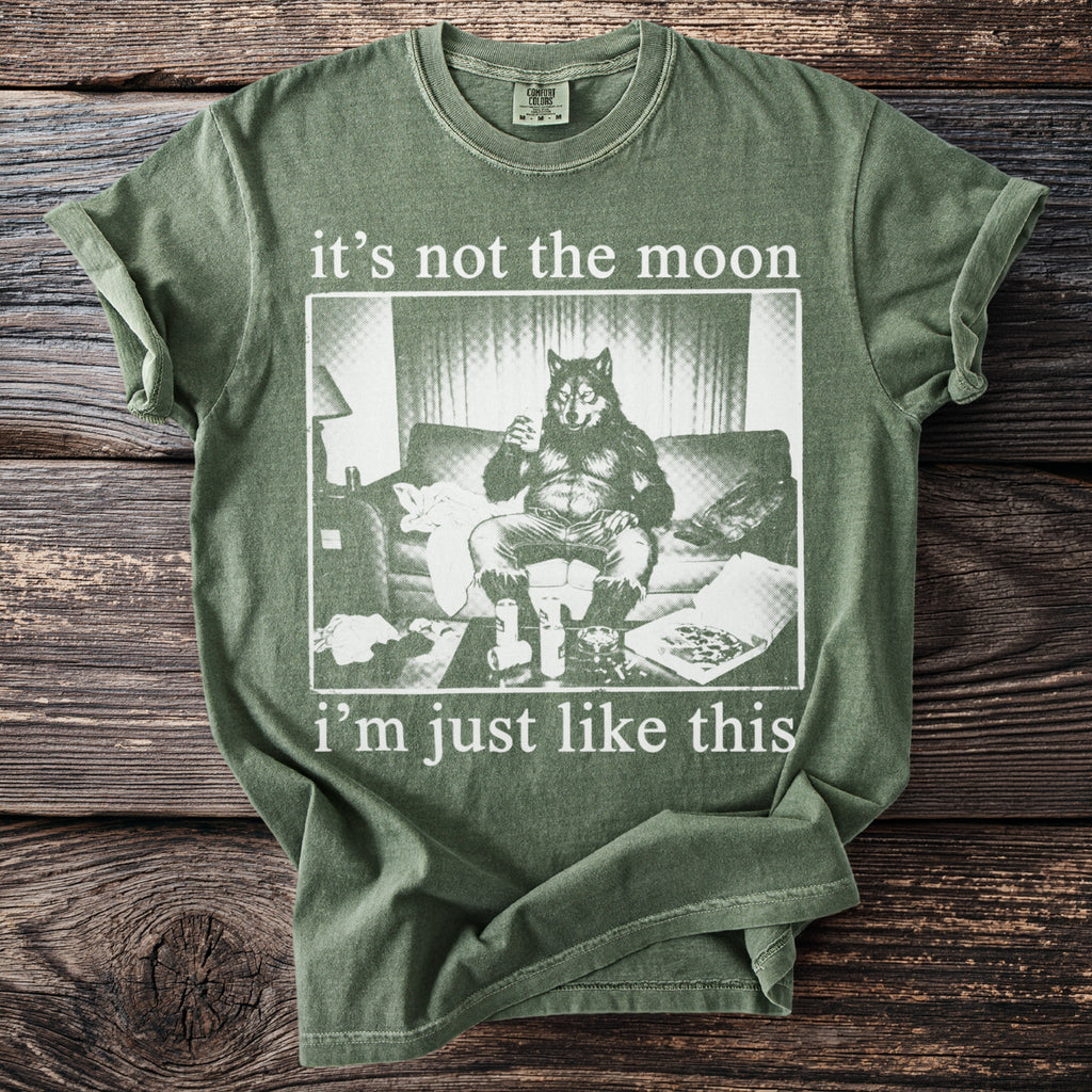 Green t-shirt with a werewolf sitting on a couch with drinks and pizza, reading "it's not the moon i'm just like this".