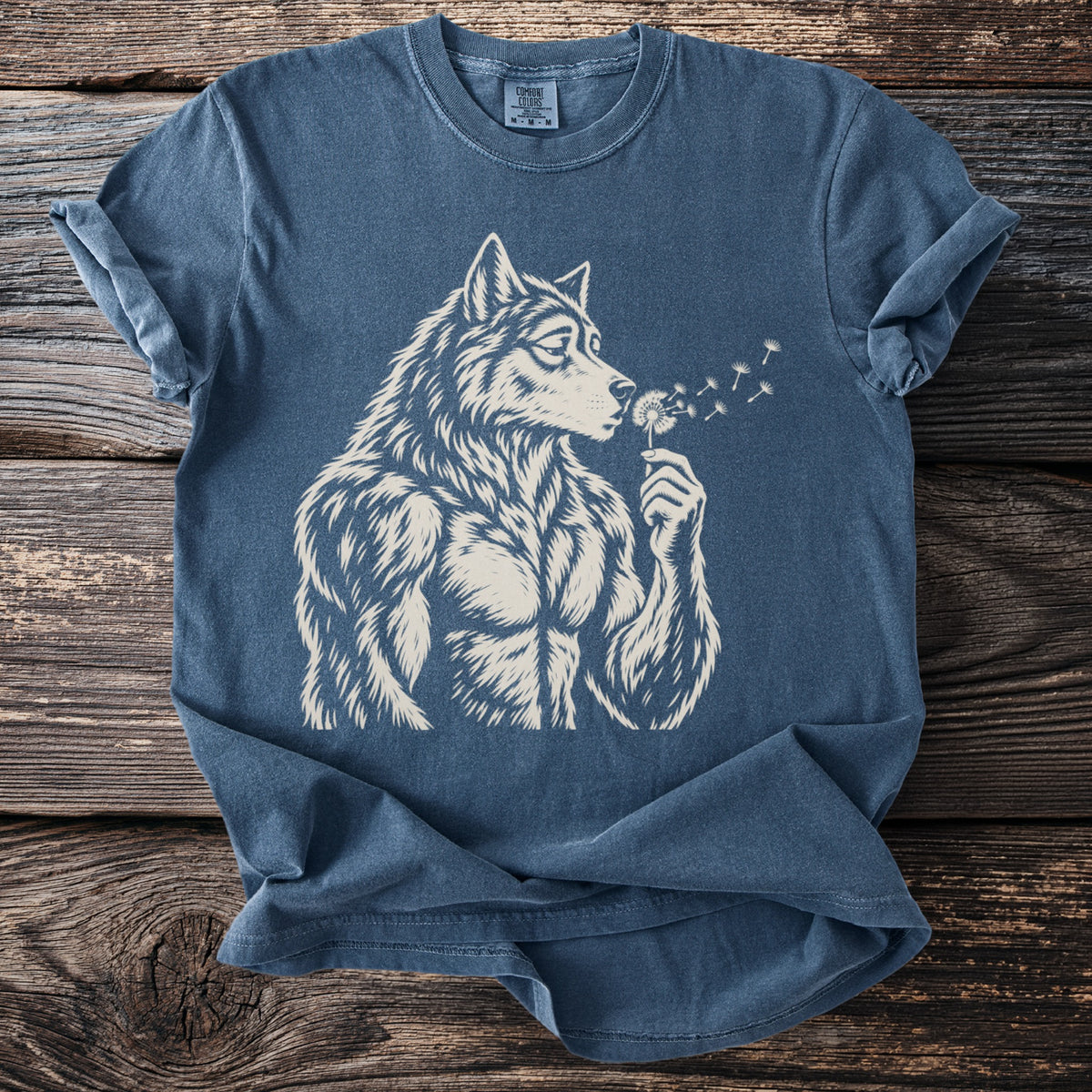Blue t-shirt with a muscular wolf blowing on a dandelion.