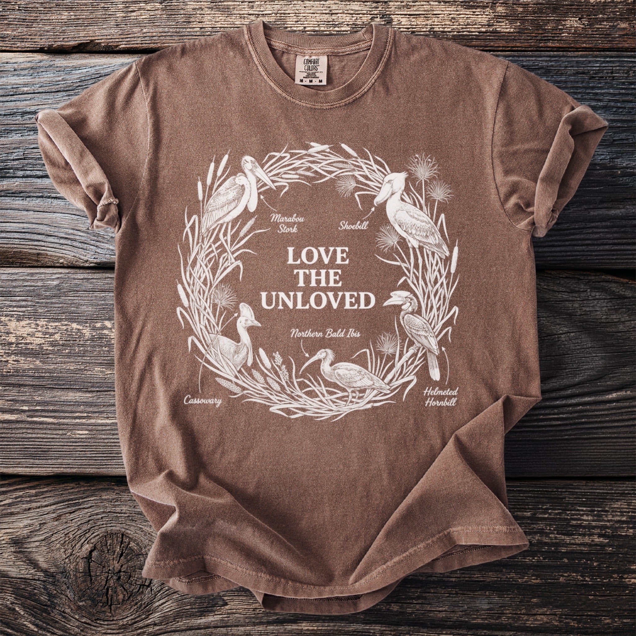 Brown T shirt with Love the Unloved and illustrations of five unusual birds.
