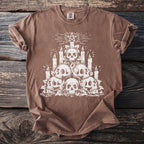 Brown t-shirt with white skull and candle graphic and a pentagram above.