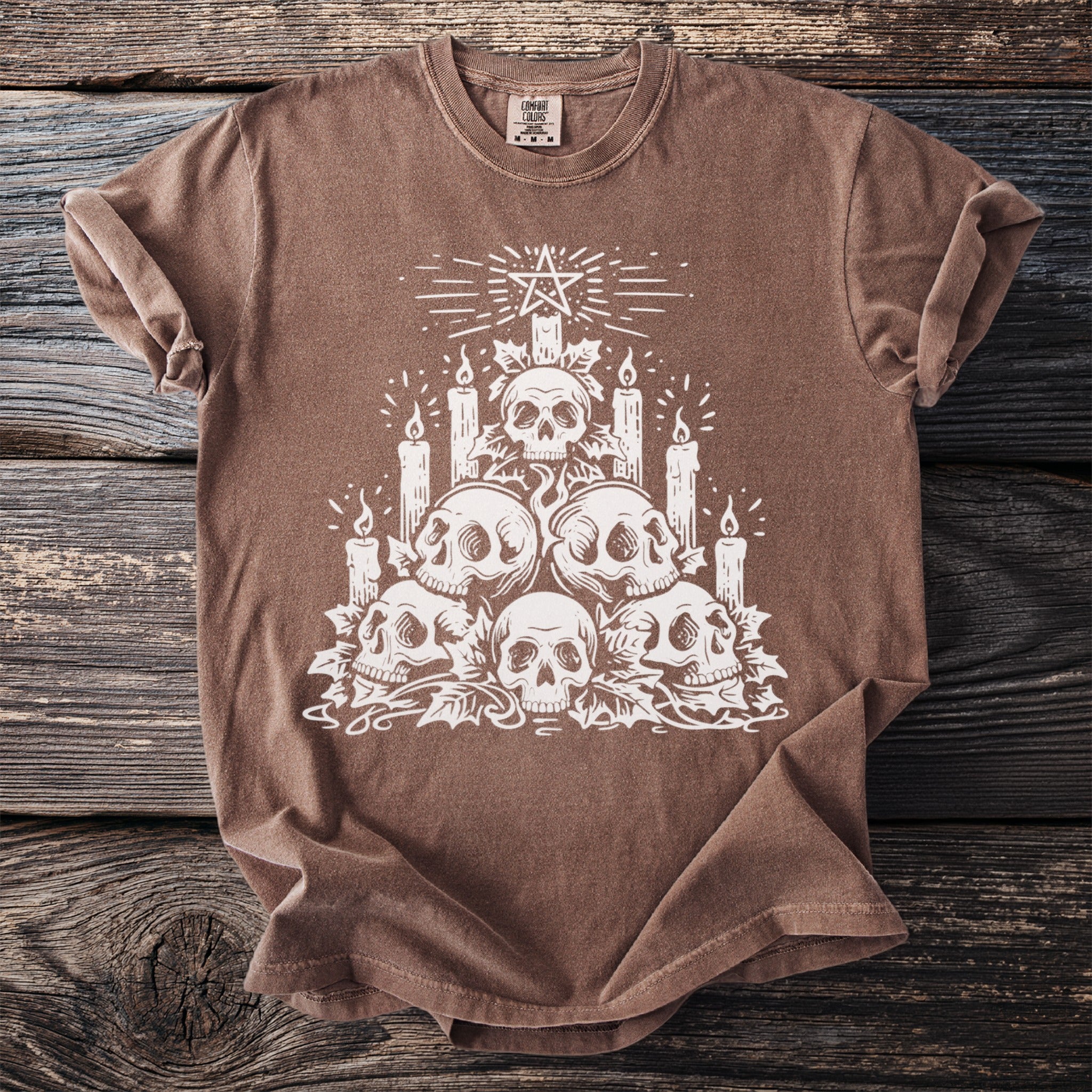 Brown t-shirt with white skull and candle graphic and a pentagram above.