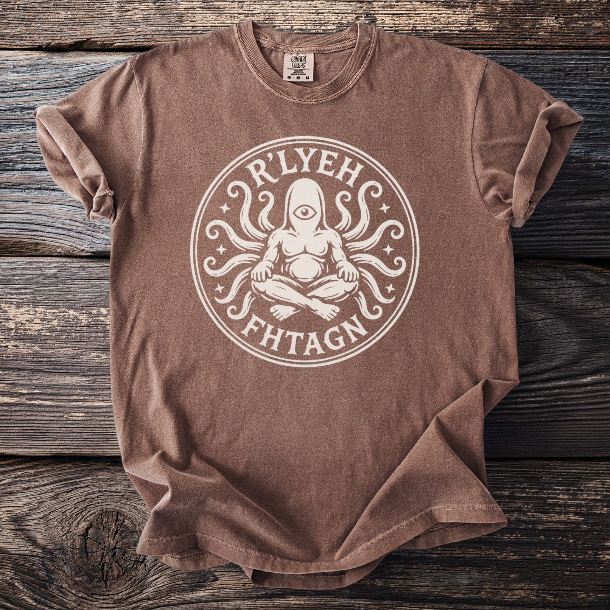 Brown t-shirt with white R'LYEH FHTAGN circular graphic and tag.