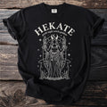 Black t-shirt with Hekate Greek night witch goddess graphic, holding torches and key.