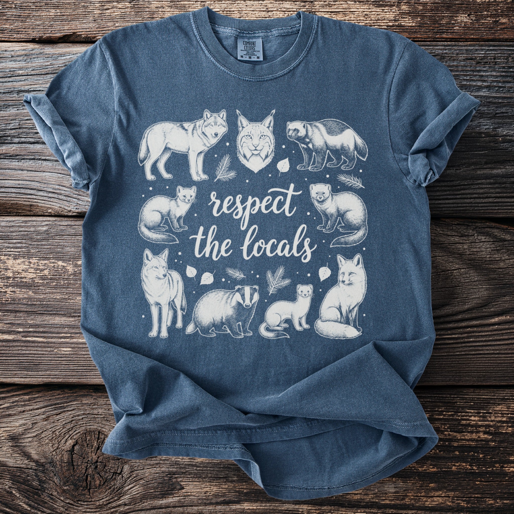 Blue t-shirt with white line art of animals and "respect the locals" text.