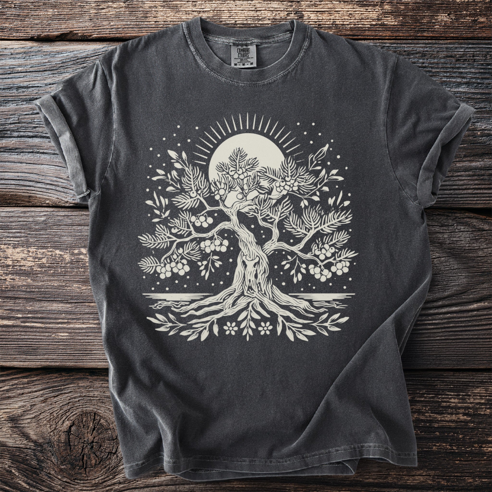 Dark grey t-shirt with a cream linework graphic of a tree under a sunburst.