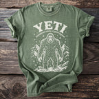 Green t-shirt with white Yeti graphic and text "YETI himalayan snow cryptid legend".