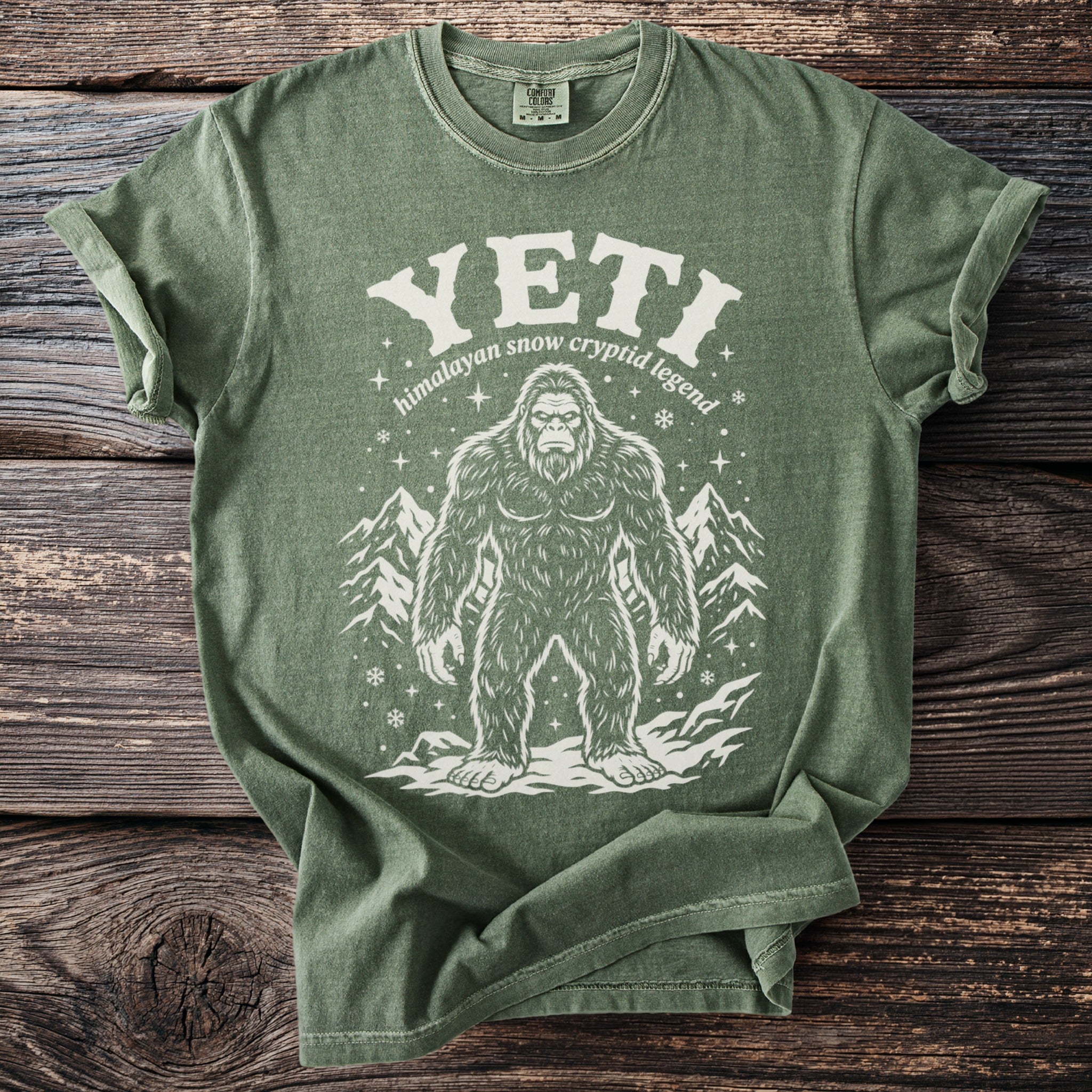 Green t-shirt with white Yeti graphic and text "YETI himalayan snow cryptid legend".