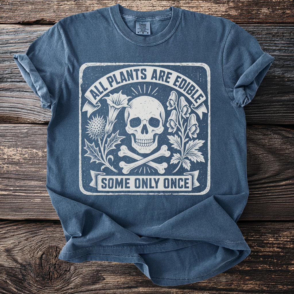 Blue t-shirt with skull, crossbones, and text "All Plants Are Edible Some Only Once".