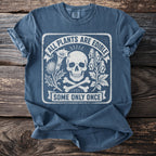 Blue t-shirt with skull, crossbones, and text "All Plants Are Edible Some Only Once".