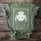 Green t-shirt with white opossum graphic and "the menace" text.