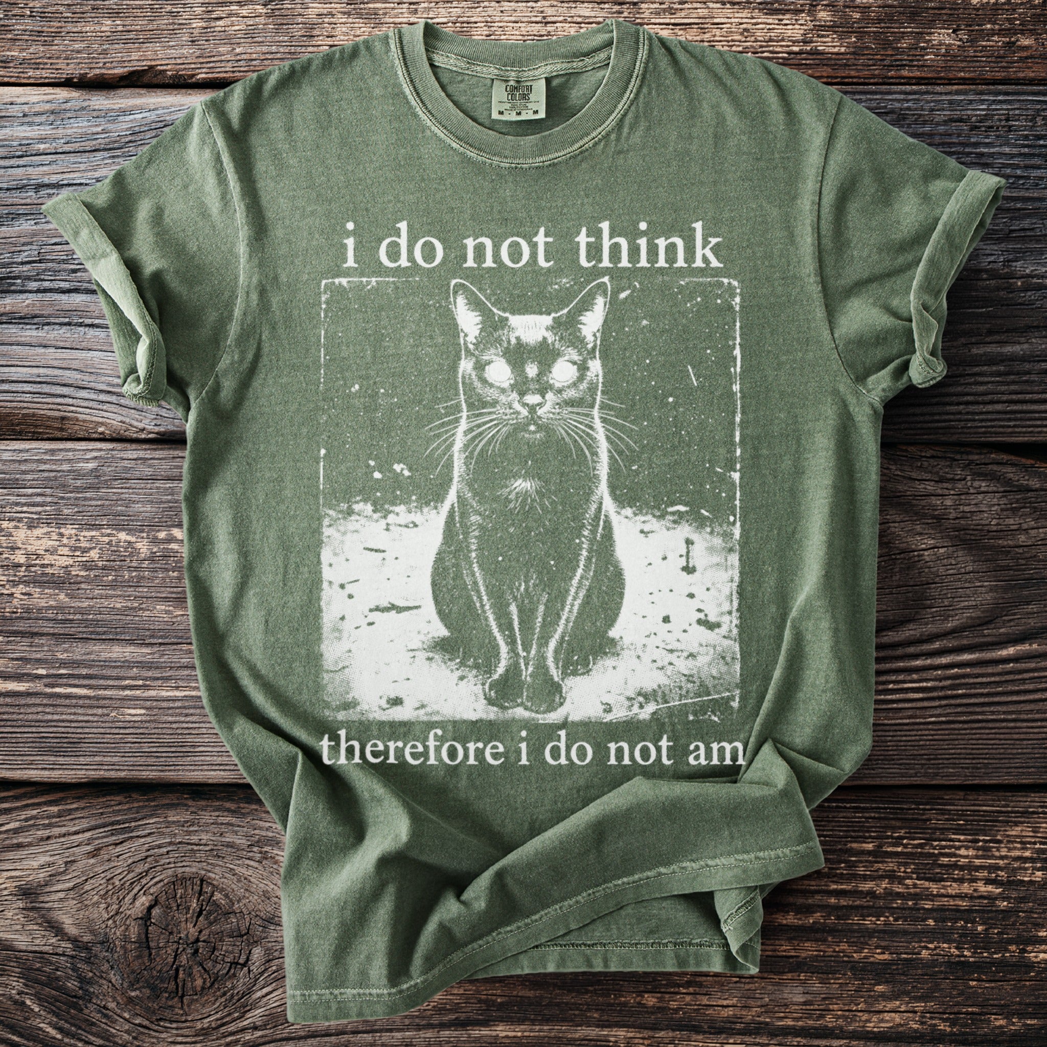 Green shirt with black cat graphic and text: "i do not think therefore i do not am."