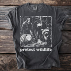 Dark t-shirt with Bigfoot, moth, opossum, frog, and raccoon graphic and "protect wildlife" text.